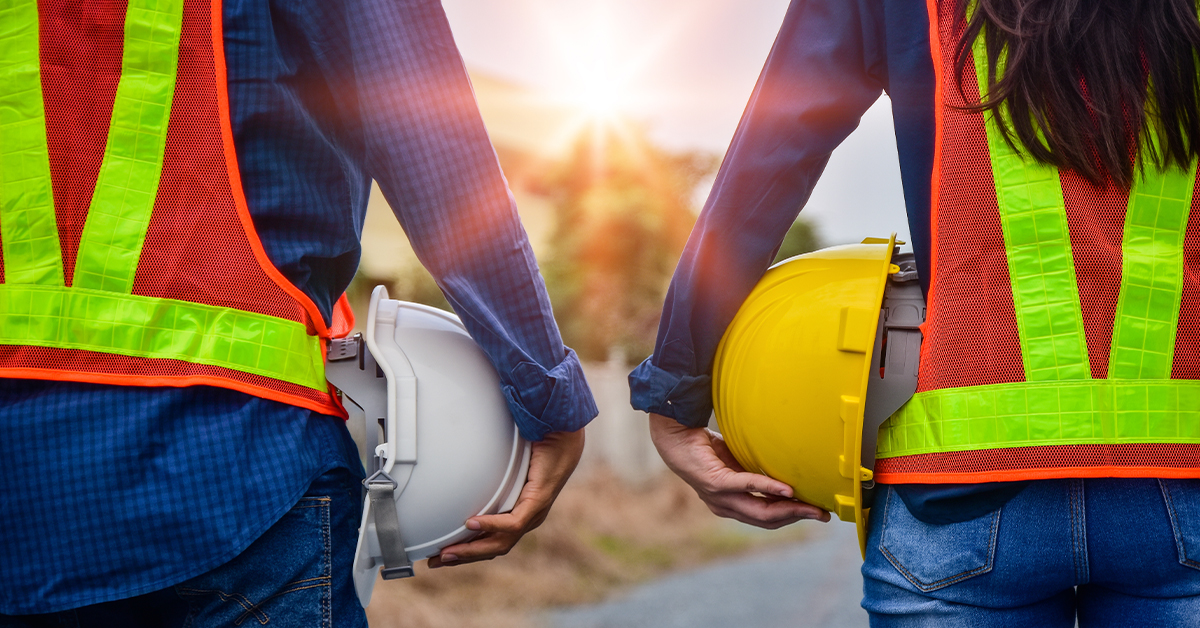 Two safety inspectors holding hard hats